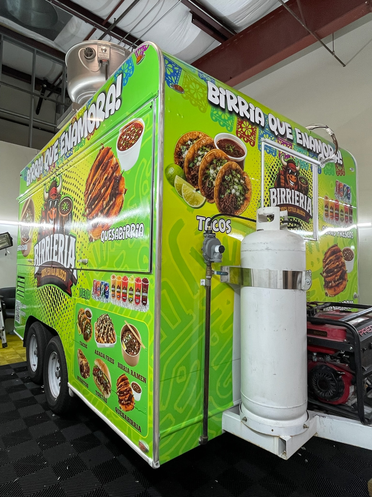 Birrieria 100% Estilo Jalisco neon green food trailer with ¡Birria que enamora! lettering